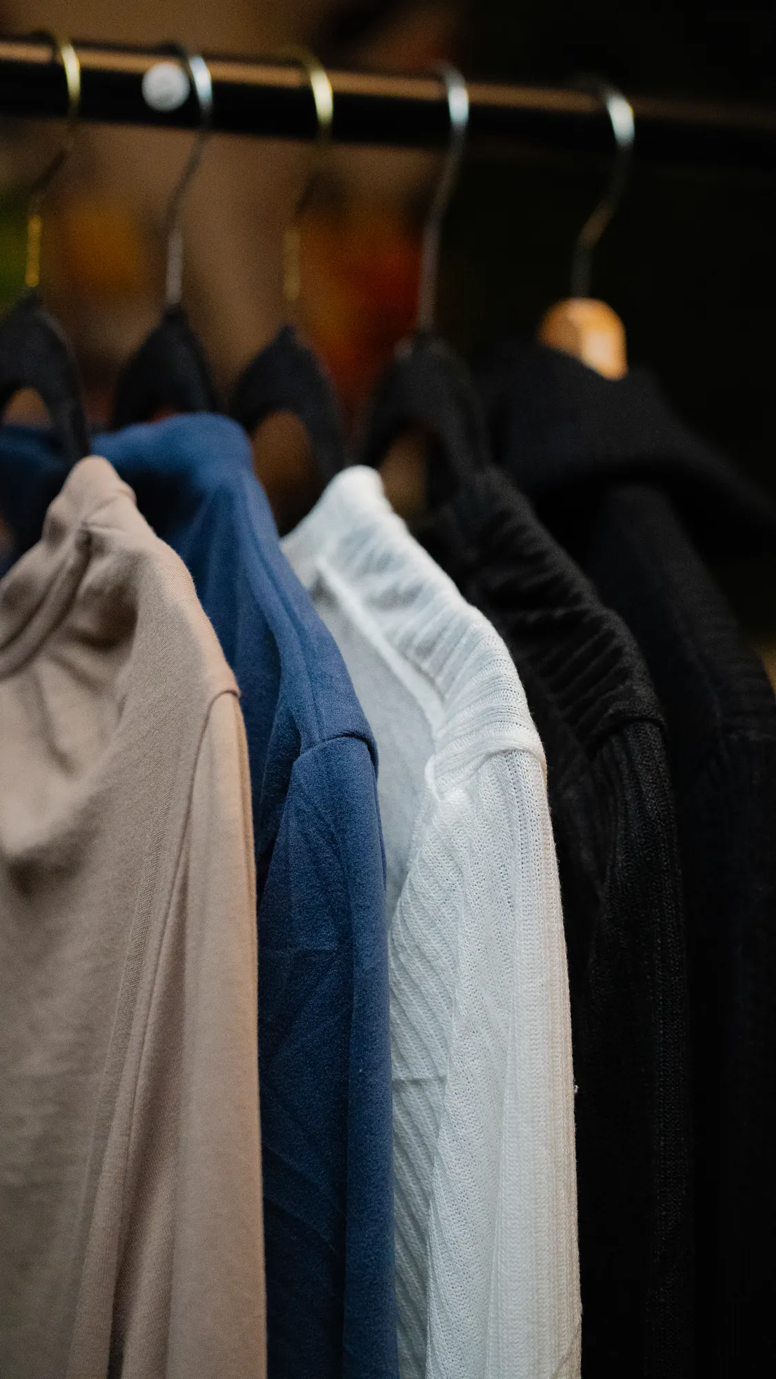 Shirts on a rack in warm light
