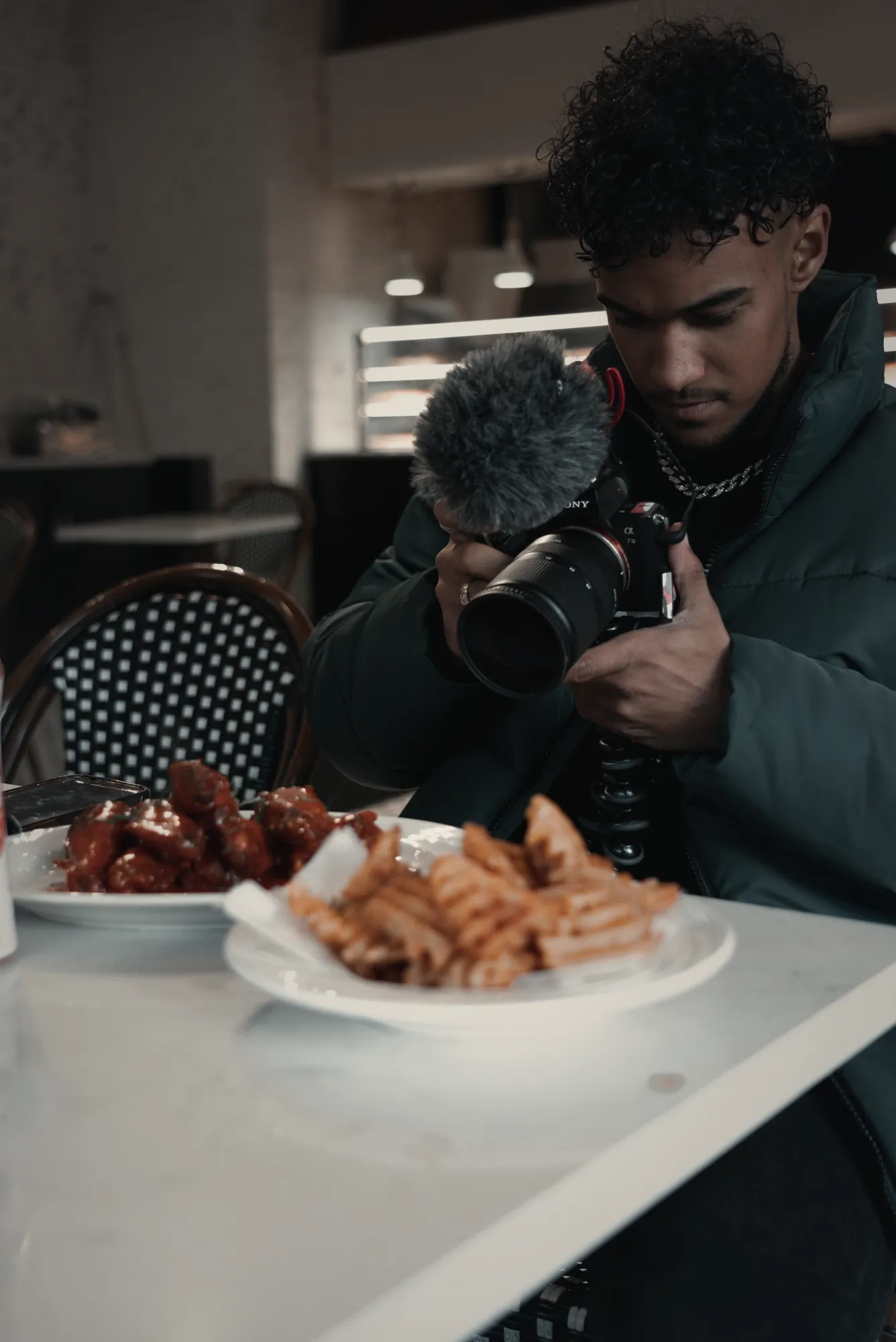 Filming a restaurant dish with a camera and shotgun mic