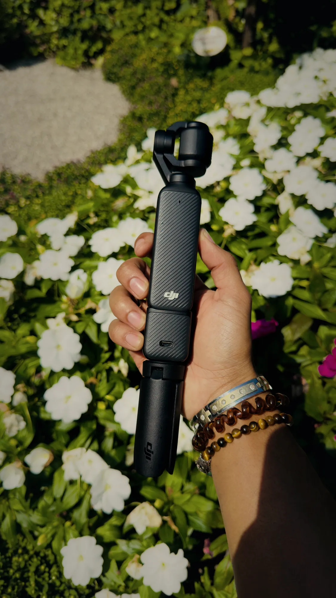 DJI Osmo Pocket held over white flowers