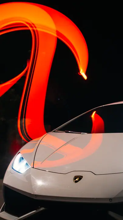 Supercar under a streak of red light