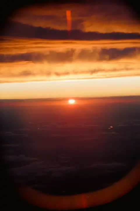 Sunset over clouds from altitude