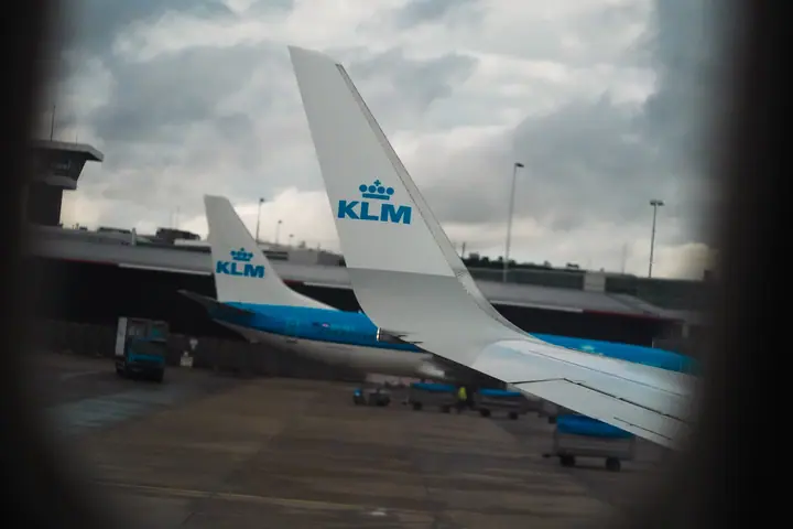 KLM aircraft seen through a window frame
