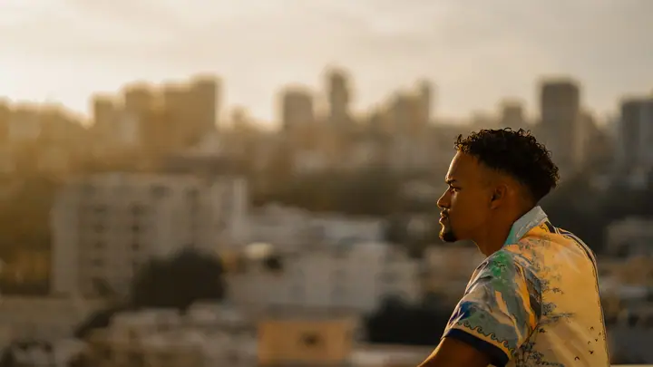 Portrait against a city skyline at golden hour