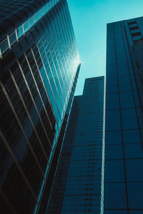 Looking up at a glass skyscraper